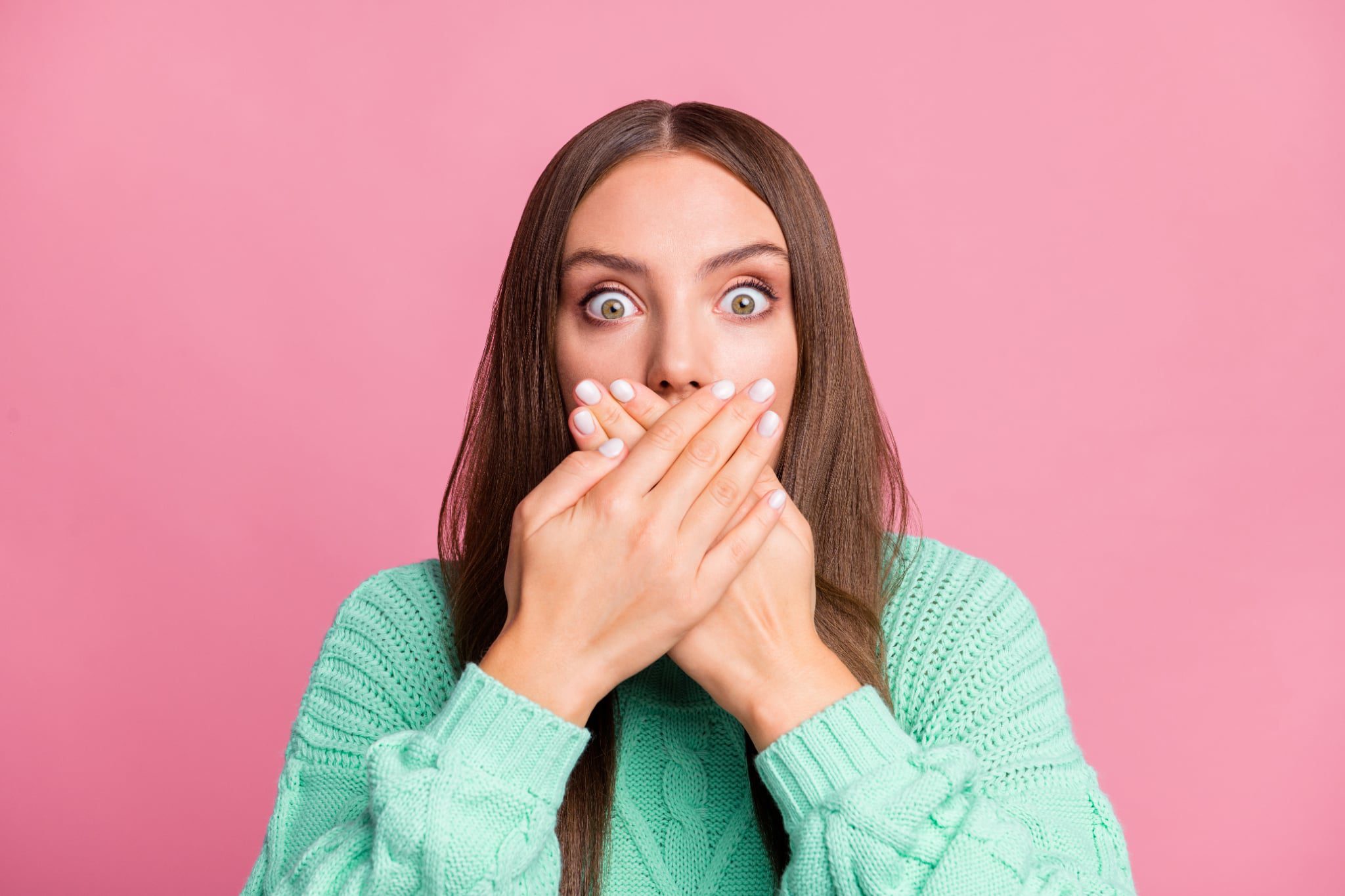 Woman covering her mouth in surprise, concept for dental implant surgery.